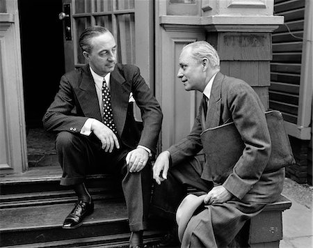 simsearch:846-05648290,k - 1930s 1940s SALESMAN AND HOME OWNER MAN SITTING TOGETHER ON FRONT STOOP TALKING SALES PRESENTATION Stock Photo - Rights-Managed, Code: 846-06112395