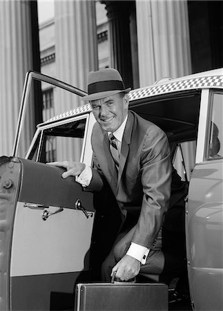 1960s BUSINESSMAN HOLDING BRIEFCASE GETTING OUT OF TAXI CAB SMILING LOOKING AT CAMERA Stock Photo - Rights-Managed, Code: 846-06112448