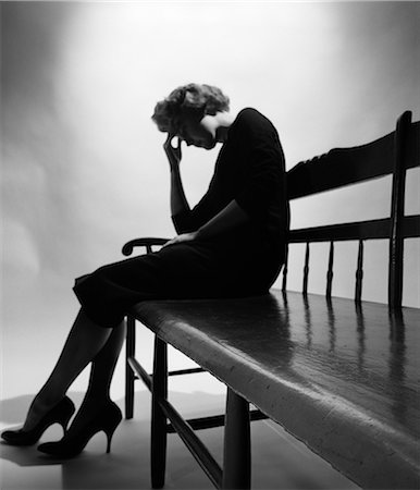simsearch:846-08030391,k - 1950s WOMAN IN SILHOUETTE SITTING AT END OF BENCH HOLDING FOREHEAD IN HAND Stock Photo - Rights-Managed, Code: 846-06112477