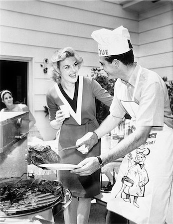 simsearch:846-05646226,k - 1960s LAUGHING COUPLE BACKYARD BBQ GRILL Stock Photo - Rights-Managed, Code: 846-07200071