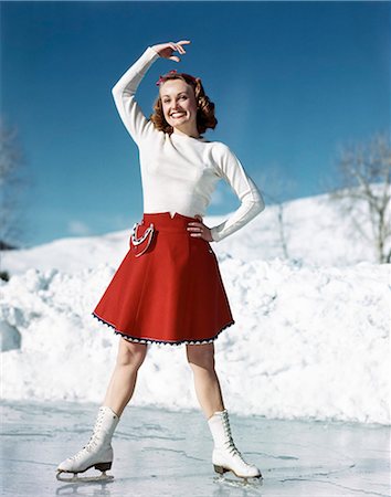 rollerskating - 1950s SMILING WOMAN WEARING WHITE SWEATER RED SKIRT ICE SKATING POSING WITH ARM OVER HEAD Stock Photo - Rights-Managed, Code: 846-07200125