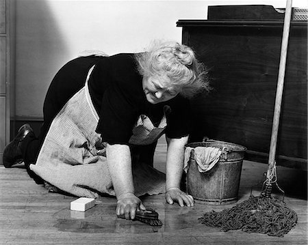 1930s SENIOR WOMAN CHARACTER CLEANING SCRUBBING FLOORS ON HANDS AND KNEES WITN SCRUB BRUS BUCKET MOP Stock Photo - Rights-Managed, Code: 846-07760706