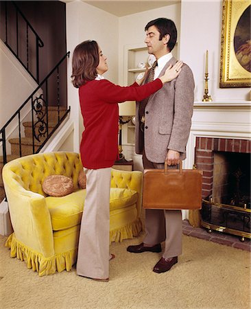 simsearch:846-07200088,k - 1970s COUPLE WOMAN WIFE ADJUSTING JACKET OF MAN HUSBAND EXECUTIVE READY TO LEAVE FOR WORK Stock Photo - Rights-Managed, Code: 846-07760733