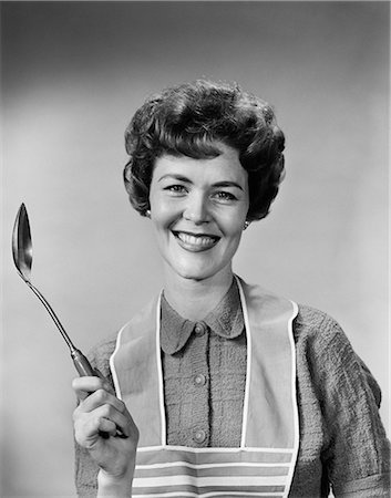 simsearch:846-06111871,k - 1950s 1960s PORTRAIT SMILING WOMAN HOUSEWIFE WEARING APRON HOLDING LARGE SPOON Stock Photo - Rights-Managed, Code: 846-08030369