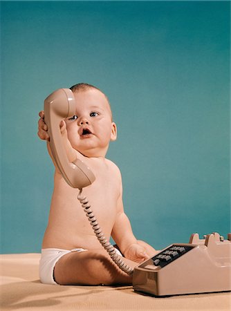 1960s BABY BOY HANDING TELEPHONE TOWARDS CAMERA Stock Photo - Rights-Managed, Code: 846-08030378