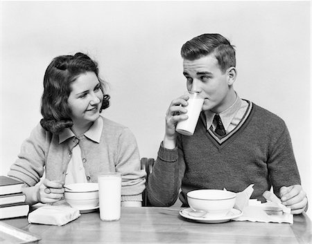 simsearch:846-08030416,k - "1940s TEENAGE GIRL AND BOY EATING SCHOOL LUNCH SOUP SANDWICHES TOGETHER BOY DRINKING MILK Stock Photo - Rights-Managed, Code: 846-08140037