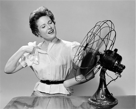 1950s WOMAN COOLING WITH SWIVEL FAN Stock Photo - Rights-Managed, Code: 846-08512754