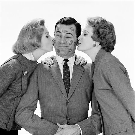 funny fashions - 1950s 1960s SINGLE MAN BEING KISSED BY TWO WOMEN Stock Photo - Rights-Managed, Code: 846-08512753