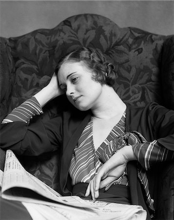 simsearch:846-08030391,k - 1930s SAD WOMAN SITTING IN HIGH BACK ARMCHAIR WEARING STRIPED BLOUSE LEANING HEAD ON HAND NEWSPAPER IN LAP Stock Photo - Rights-Managed, Code: 846-09012746