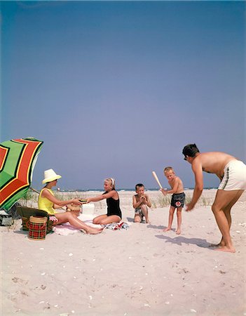 dad son bath photos - 1960s FAMILY ON SUMMER SANDY BEACH MOTHER PICNICKING WITH DAUGHTER FATHER PLAYING PITCHING BASEBALL TO SONS Stock Photo - Rights-Managed, Code: 846-09012839