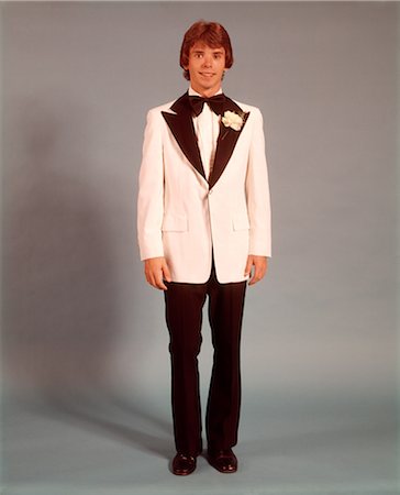 1970s TEEN BOY FULL FIGURE PORTRAIT WEARING FORMAL TUXEDO WHITE JACKET FOR PROM DATE STANDING LOOKING AT CAMERA Stock Photo - Rights-Managed, Code: 846-09012943