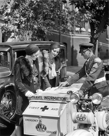 1930s TWO WOMEN MOTORISTS TALKING TO AAA MOBILE SERVICE OFFICER RIDING ROAD SERVICE AND FIRST AID EMERGENCY SIDECAR MOTORCYCLE Stock Photo - Rights-Managed, Code: 846-09013069