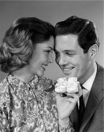 1960s COUPLE SMILING HOLDING  A PAIR OF BABY BOOTIES Stock Photo - Rights-Managed, Code: 846-09013111