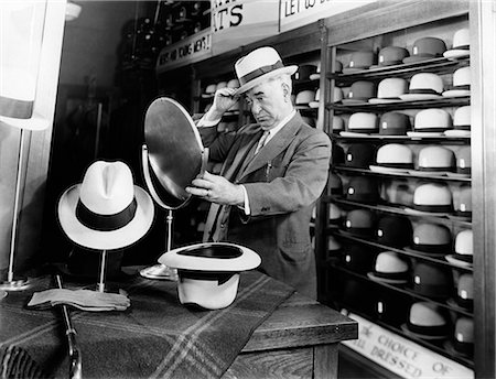 simsearch:846-08030416,k - 1940s SENIOR MAN TRYING ON HATS LOOKING IN MIRROR IN HAT STORE Stock Photo - Rights-Managed, Code: 846-09013133