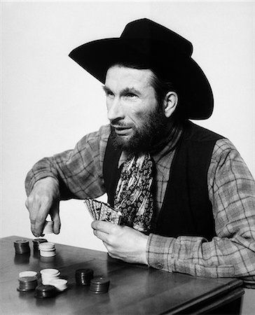 simsearch:846-05645665,k - 1930s BEARDED MAN COWBOY PLAYING CARDS GAMBLING BETTING POKER CHIPS Stock Photo - Rights-Managed, Code: 846-09085268