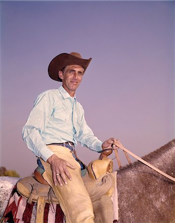 simsearch:846-02795969,k - 1960s PORTRAIT SMILING WESTERN COWBOY IN SADDLE RIDING HORSE HOLDING REINS LOOKING AT CAMERA Stock Photo - Rights-Managed, Code: 846-09085351