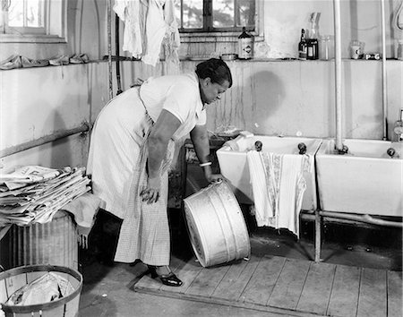 fat black woman - 1940s AFRICAN AMERICAN OVERWEIGHT WOMAN STOOPING IN LAUNDRY ROOM PICKING UP GALVANIZED WASH TUB Stock Photo - Rights-Managed, Code: 846-09085370