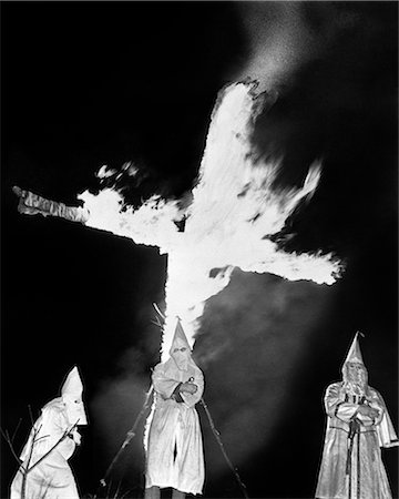 simsearch:846-05648291,k - 1930s HOODED MEMBERS OF KKK KU KLUX KLAN STANDING IN FRONT OF BURNING CROSS Stock Photo - Rights-Managed, Code: 846-09085389