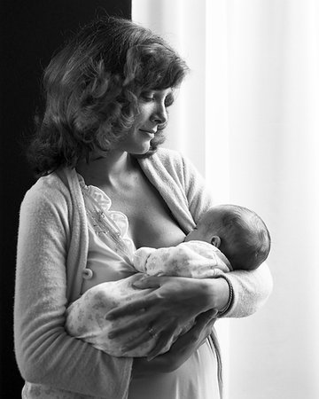 SERENE YOUNG MOTHER STANDING HOLDING NURSING INFANT BABY SON Stock Photo - Rights-Managed, Code: 846-09181576