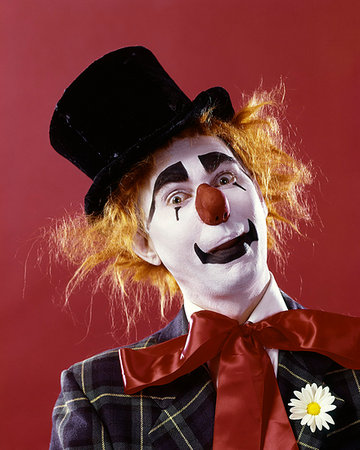 performer (male) - 1970s SILLY WHITE FACE RED NOSE CLOWN LOOKING AT CAMERA WEARING TOP HAT ORANGE HAIR WIG PLAID JACKET AND RED RIBBON NECK TIE Stock Photo - Rights-Managed, Code: 846-09181732