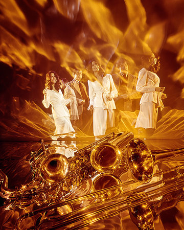 simsearch:846-05648202,k - 1960s 1970s TRIPTYCH MULTIPLE EXPOSURE YOUNG COUPLE ENTERTAINERS PERFORMING WOMAN IN WHITE HORNS & FLAMES HOT MUSIC FOREGROUND Stock Photo - Rights-Managed, Code: 846-09181743