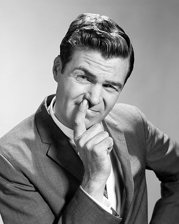 facial - 1960s PORTRAIT BUSINESSMAN POINTING AT NOSE SQUINTING LOOKING AT CAMERA Stock Photo - Rights-Managed, Code: 846-09181939