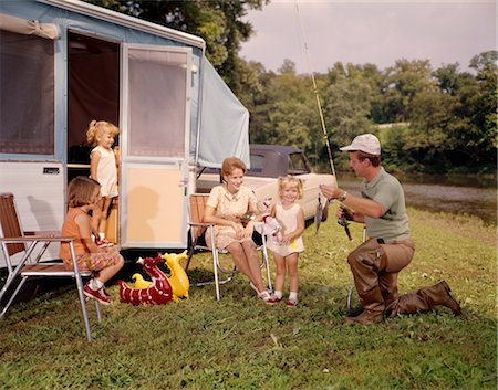 1960s FAMILY WITH THREE DAUGHTERS BY TRAILER WITH FISHING AND SWIM GEAR MAN WOMAN GIRL ANGLING LAKE VACATION Stock Photo - Rights-Managed, Code: 846-02794111