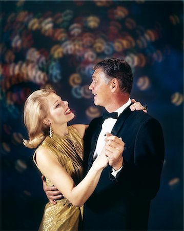 simsearch:846-02791806,k - 1960s COUPLE IN FORMAL CLOTHES DANCING MULTIPLE LIGHT BACKGROUND CELEBRATION ANNIVERSARY MAN WOMAN Stock Photo - Rights-Managed, Code: 846-02794170