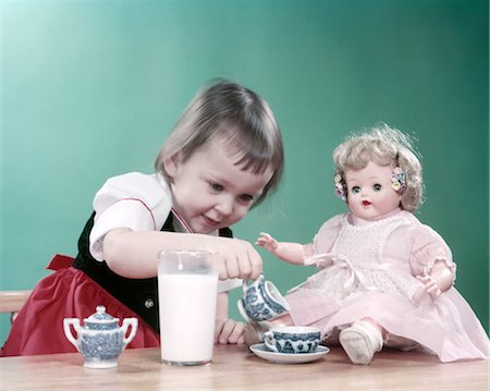 saucer - 1950s LITTLE GIRL TODDLER AND BABY DOLL HAVING TEA PARTY BLUE WILLOW CUP SAUCER AND BIG GLASS OF MILK Stock Photo - Rights-Managed, Code: 846-02794205