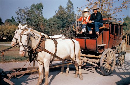 simsearch:846-02793153,k - OLD BUTTERFIELD STAGECOACH KNOTTS BERRY FARM CALIFORNIA TWO WHITE MULES TEAM HARNESS PULL RED WAGON DRIVER & COWBOY Stock Photo - Rights-Managed, Code: 846-02794420