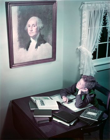 1940s 1950s BOY AT DESK READING STUDYING LOOK UP AT PAINTING ON WALL OF GEORGE WASHINGTON HISTORY PATRIOTISM Stock Photo - Rights-Managed, Code: 846-02794434