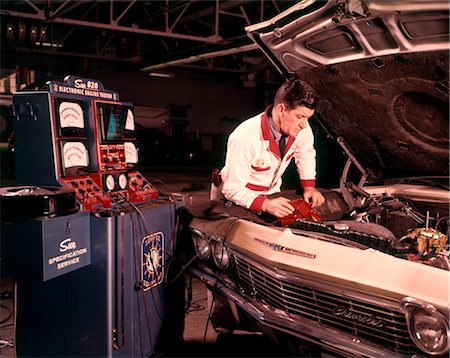 1960s MAN AUTO MECHANIC WORKING CAR ENGINE CONNECTED TO DIAGNOSTIC EQUIPMENT MEN MECHANIC CAR AUTOMOBILE Stock Photo - Rights-Managed, Code: 846-02794630