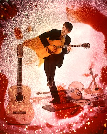 simsearch:846-02794130,k - 1970 1970s YOUNG MAN MUSICIAN PLAYING GUITAR ROCK MUSIC SURROUNDED BY SPECIAL EFFECTS GUITARS COLORS PSYCHEDELIC Stock Photo - Rights-Managed, Code: 846-02794759
