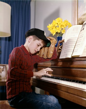 piano practice - 1960s 1970s IMPATIENT ANNOYED LOOKING BOY WITH BASEBALL CAP AND GLOVE PRACTICING PIANO LESSON Stock Photo - Rights-Managed, Code: 846-02794850