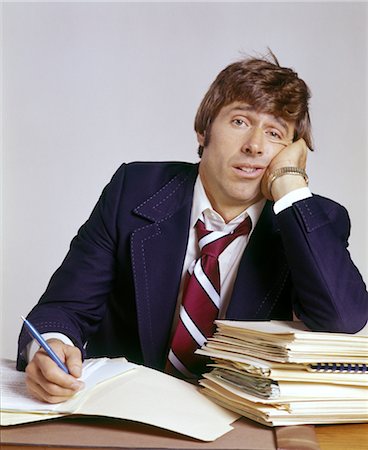 simsearch:846-02795767,k - 1970s MAN WITH HEADACHE BUSINESS OFFICE OVERWHELMED BY PAPERWORK Stock Photo - Rights-Managed, Code: 846-02794905