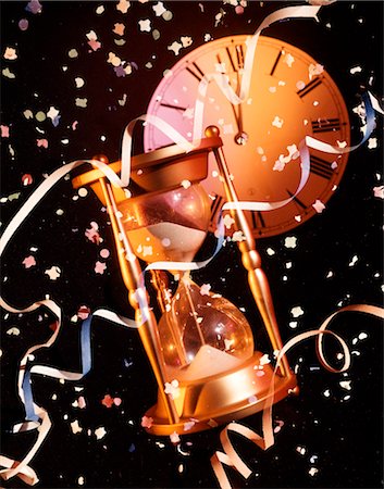 NEW YEARS STILL LIFE HOURGLASS CLOCK AND CONFETTI Stock Photo - Rights-Managed, Code: 846-02794902