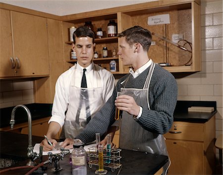 experimenting - 1960s MAN COLLEGE STUDENT IN CHEMISTRY LABORATORY LOOKING AT SOLUTION IN BEAKER Stock Photo - Rights-Managed, Code: 846-02795102