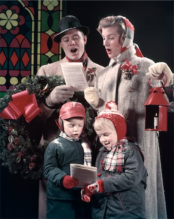 1950s FAMILY SINGING CAROLS DAD MAN HAS WREATH OVER ARM MOM WOMAN HOLDS RED LANTERN BOY GIRL MUSIC SONG SNOW OUTDOOR Stock Photo - Rights-Managed, Code: 846-02795250