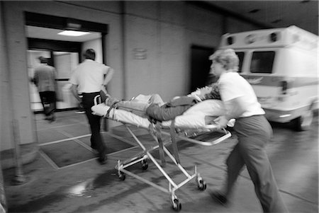 1980s EMT TEAM RUSHING PATIENT INTO HOSPITAL ON STRETCHER Stock Photo - Rights-Managed, Code: 846-02795393