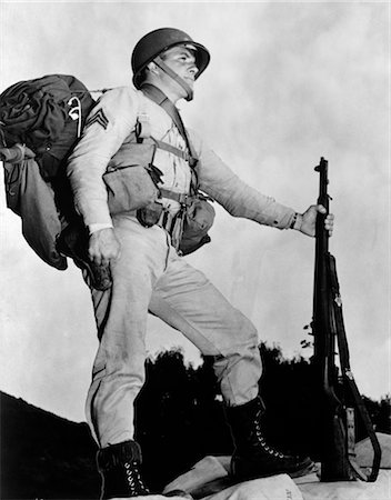 simsearch:846-02797725,k - 1940s SERGEANT IN ARMY UNIFORM IN PROFILE POSING WITH RIFLE HELMET BACKPACK AND BOOTS Stock Photo - Rights-Managed, Code: 846-02795481