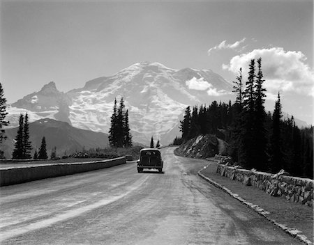 simsearch:846-02796653,k - 1930s SEDAN AUTOMOBILE DRIVING HIGH MOUNTAIN ROAD TOWARDS SNOW CAPPED MOUNT RAINIER WASHINGTON STATE USA Stock Photo - Rights-Managed, Code: 846-02795562