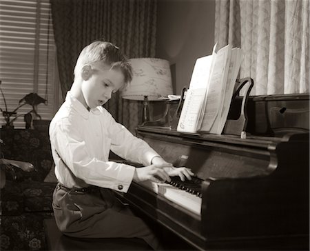 1950s BOY PRACTICING PIANO MUSIC LESSON PLAYING SCALES Stock Photo - Rights-Managed, Code: 846-02795618