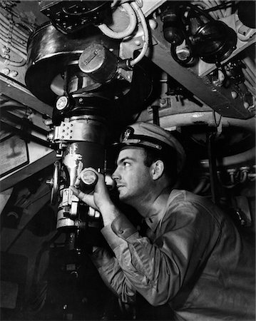 1940s SUBMARINE OFFICER CAPTAIN LOOKING THROUGH PERISCOPE OBSERVE UNDERWATER NAVAL UNIFORM WW2 VISION OBSERVATION VINTAGE Stock Photo - Rights-Managed, Code: 846-02795716