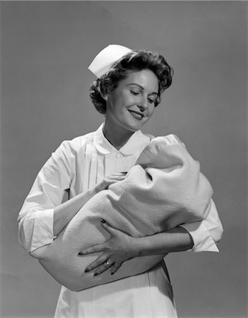 1950s NURSE HOLDING NEWBORN INFANT WRAPPED IN BLANKET Stock Photo - Rights-Managed, Code: 846-02795712