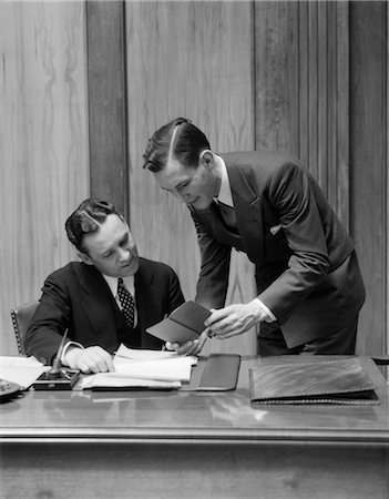 1930s TWO MEN IN OFFICE AT DESK LOOKING THROUGH BROCHURE Stock Photo - Rights-Managed, Code: 846-02795788