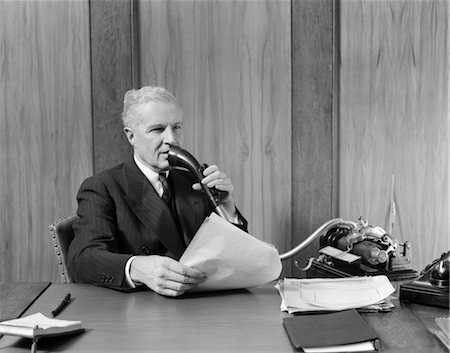 simsearch:846-02792220,k - 1930s ELDERLY MALE EXECUTIVE SITTING AT DESK SPEAKING INTO DICTAPHONE Stock Photo - Rights-Managed, Code: 846-02795832