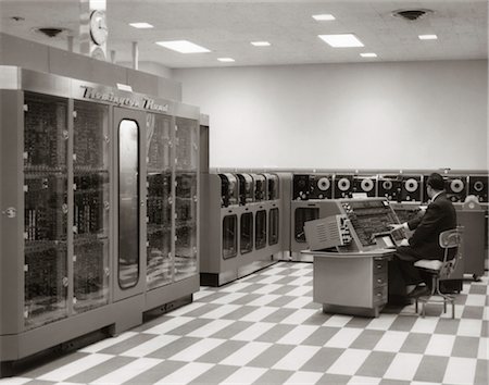 simsearch:846-02795767,k - 1950s MAN PROGRAMMER SITTING AT CONSOLE IN DATA PROCESSING ROOM WITH REMINGTON RAND UNIVAC COMPUTER AND TAPE DRIVES Stock Photo - Rights-Managed, Code: 846-02795964