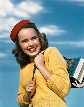 1940s 1950s SMILING TEEN GIRL RED TAM YELLOW SWEATER HOLDING SCHOOL BOOKS OVER SHOULDER Stock Photo - Rights-Managed, Code: 846-02796123