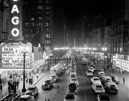 simsearch:846-02795606,k - 1950s 1953 NIGHT SCENE OF CHICAGO STATE STREET WITH TRAFFIC AND MOVIE MARQUEE WITH PEDESTRIANS ON THE SIDEWALKS Stock Photo - Rights-Managed, Code: 846-02796650