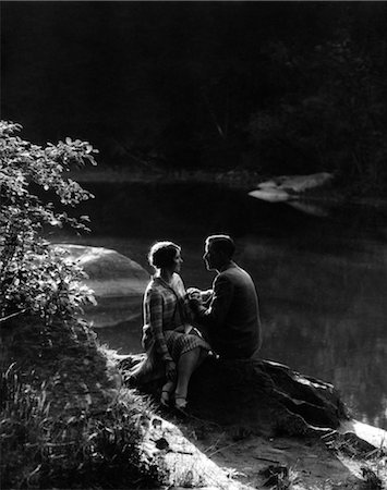 romantic couple silhouette - 1920s 1930s ROMANTIC COUPLE SITTING BY STREAM IN SOFT MOODY AFTERNOON SUNLIGHT Stock Photo - Rights-Managed, Code: 846-02796686